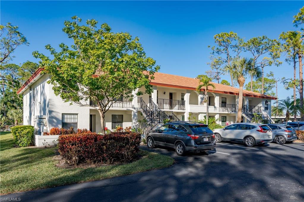 905 Augusta Boulevard, Unit 7 Naples, FL 34113 - Photo 21 of 42 a couple of cars parked in front of a house