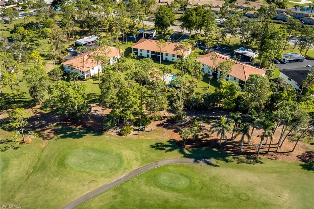 905 Augusta Boulevard, Unit 7 Naples, FL 34113 - Photo 30 of 42 a view of a house with a yard