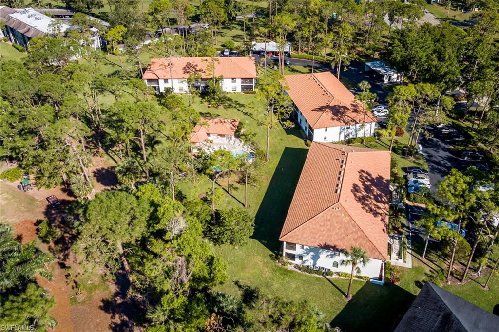 905 Augusta Boulevard, Unit 7 Naples, FL 34113 - Photo 32 of 42 an aerial view of a house with a yard and lake view