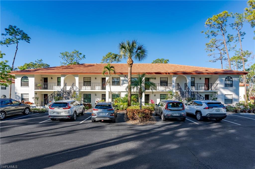 905 Augusta Boulevard, Unit 7 Naples, FL 34113 - Photo 36 of 42 a car parked in front of a building