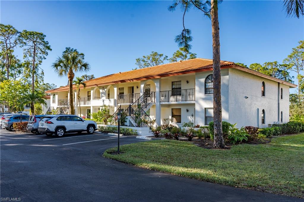 905 Augusta Boulevard, Unit 7 Naples, FL 34113 - Photo 38 of 42 a front view of a house with a garden