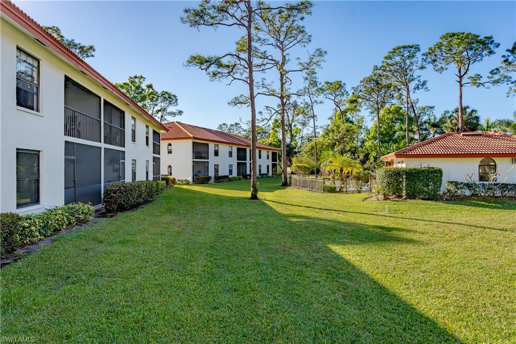 905 Augusta Boulevard, Unit 7 Naples, FL 34113 - Photo 39 of 42 a house with garden in front of it