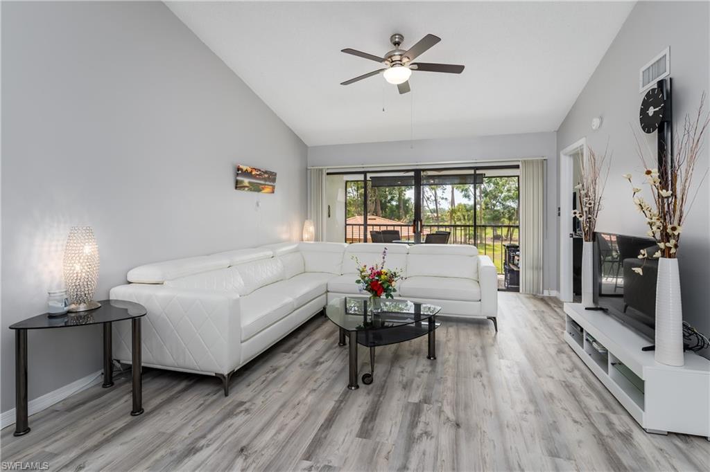 905 Augusta Boulevard, Unit 7 Naples, FL 34113 - Photo 5 of 42 a living room with furniture and a large window