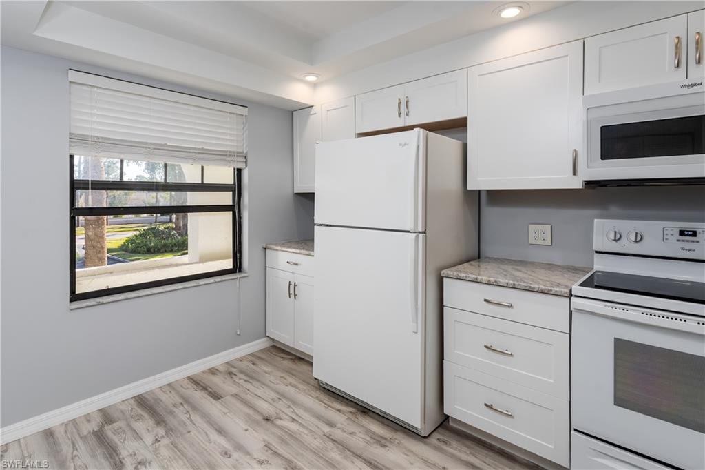 905 Augusta Boulevard, Unit 7 Naples, FL 34113 - Photo 9 of 42 a kitchen with a refrigerator stove and microwave