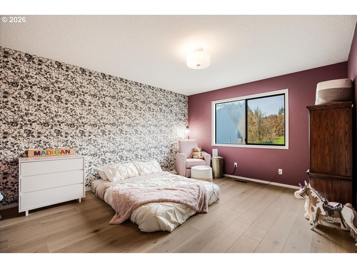 13492 South Warnock Road Oregon City, OR 97045 - Photo 13 of 48 a bedroom with a bed and a night stand