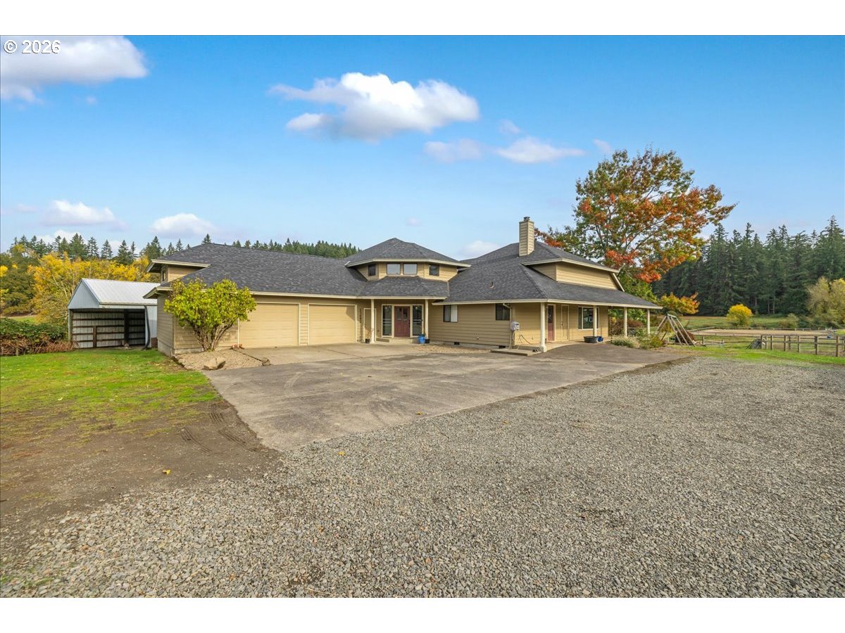 13492 South Warnock Road Oregon City, OR 97045 - Photo 19 of 48 a view of a house with a yard and a large tree