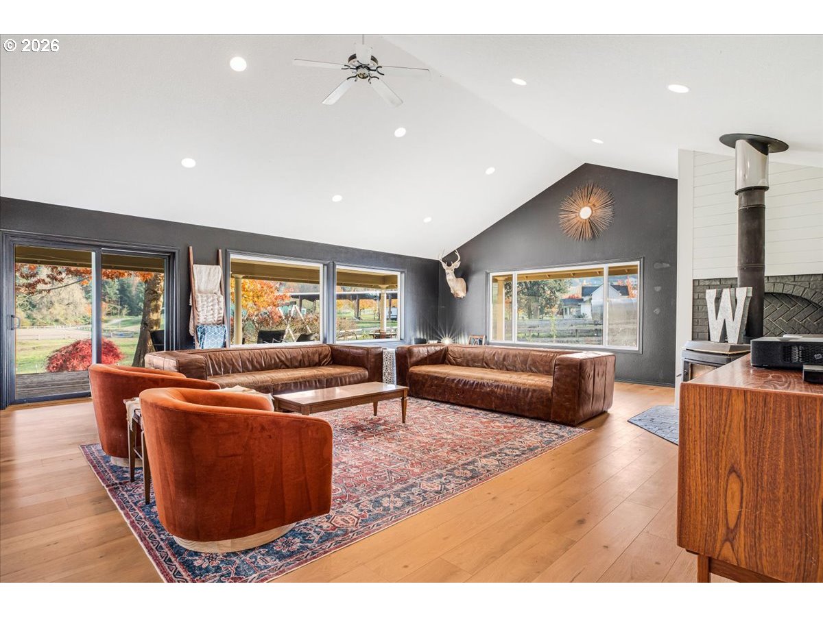 13492 South Warnock Road Oregon City, OR 97045 - Photo 4 of 48 a living room with furniture and a wooden floor