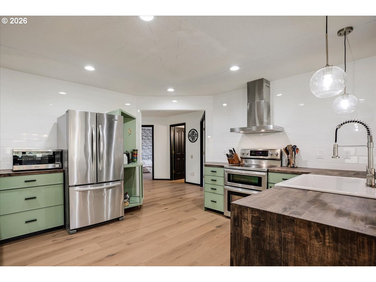 13492 South Warnock Road Oregon City, OR 97045 - Photo 6 of 48 a kitchen with stainless steel appliances granite countertop a refrigerator a stove and a sink