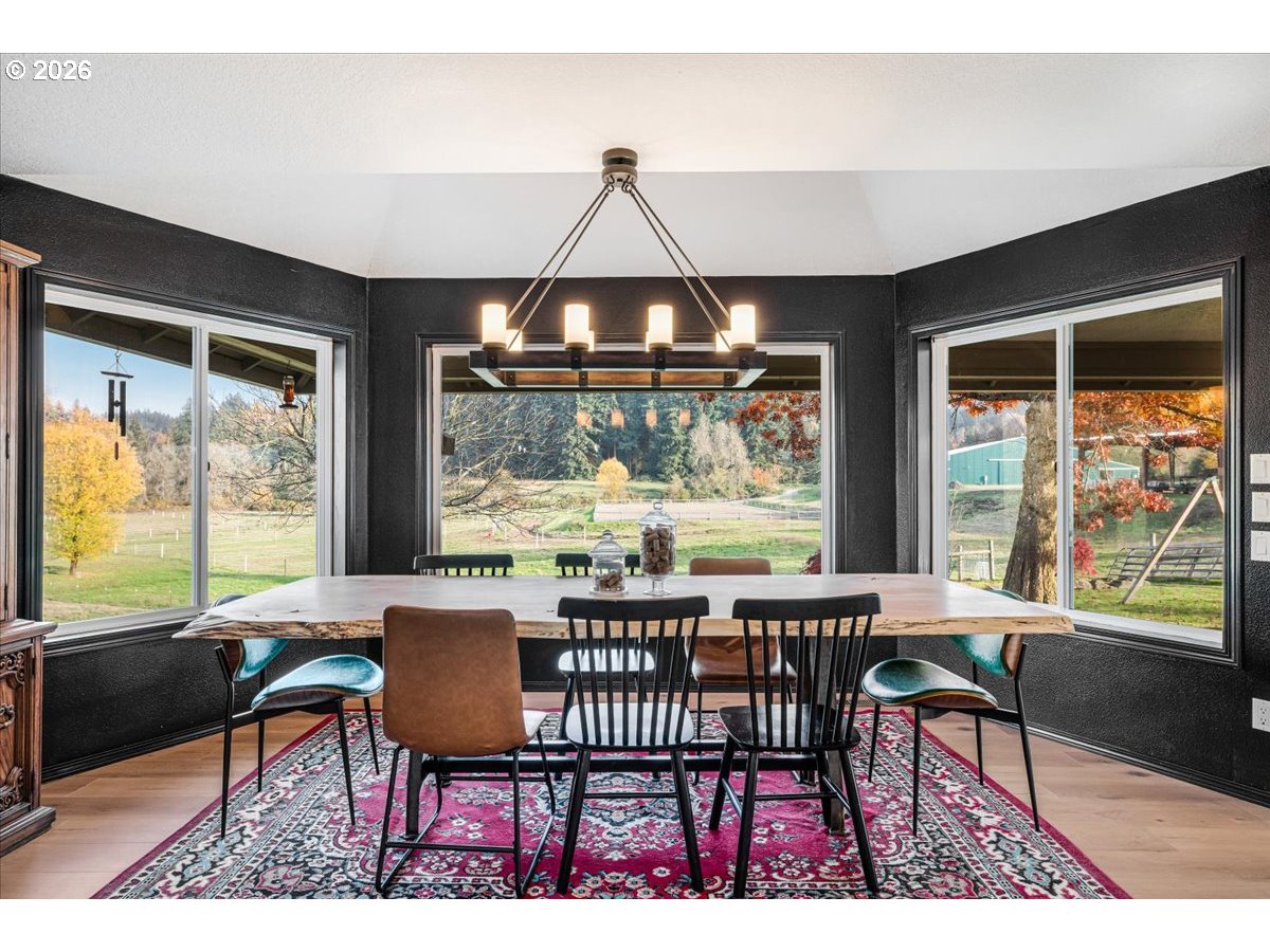 13492 South Warnock Road Oregon City, OR 97045 - Photo 8 of 48 a dining room with furniture a chandelier and wooden floor
