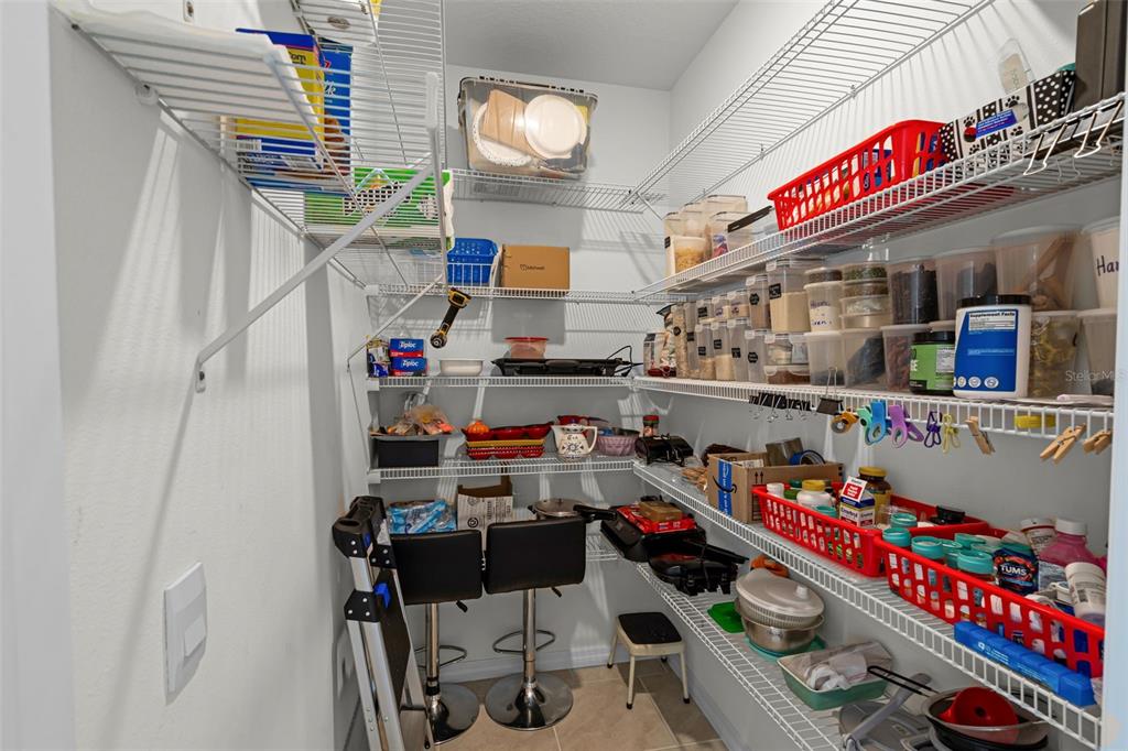 3435 Yellowtop Loop Clermont, FL 34714 - Photo 12 of 42 a utility room with fridge and rack