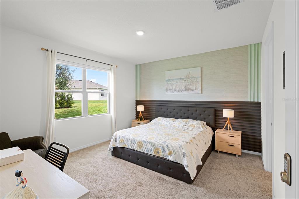 3435 Yellowtop Loop Clermont, FL 34714 - Photo 13 of 42 a bedroom with a bed and a couch