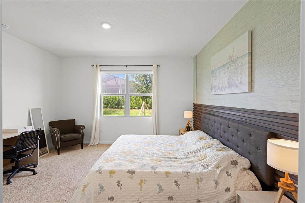 3435 Yellowtop Loop Clermont, FL 34714 - Photo 14 of 42 a bedroom with a bed and a chair