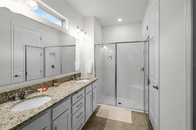 a bathroom with a granite countertop sink mirror and double