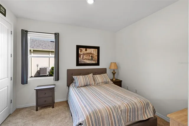 a bedroom with a bed and window