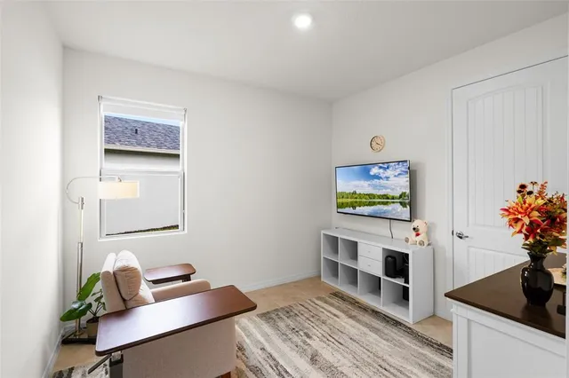 a bedroom with furniture and a potted plant