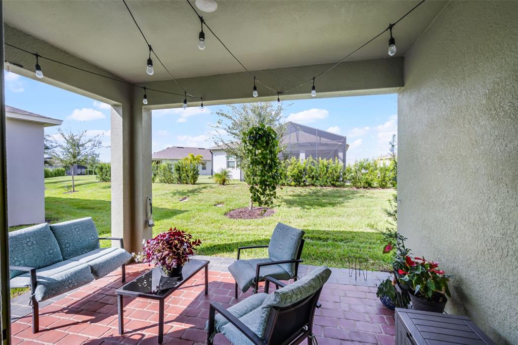 3435 Yellowtop Loop Clermont, FL 34714 - Photo 20 of 42 a view of a porch with furniture and a yard