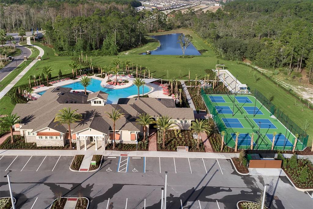 3435 Yellowtop Loop Clermont, FL 34714 - Photo 24 of 42 an aerial view of a house with a garden and lake view
