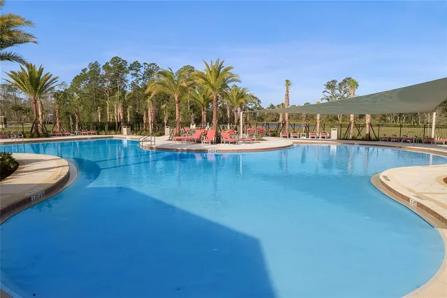 a view of a swimming pool with lounge chairs