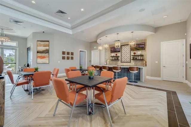 an open kitchen with granite countertop a kitchen island white cabinetry and appliances