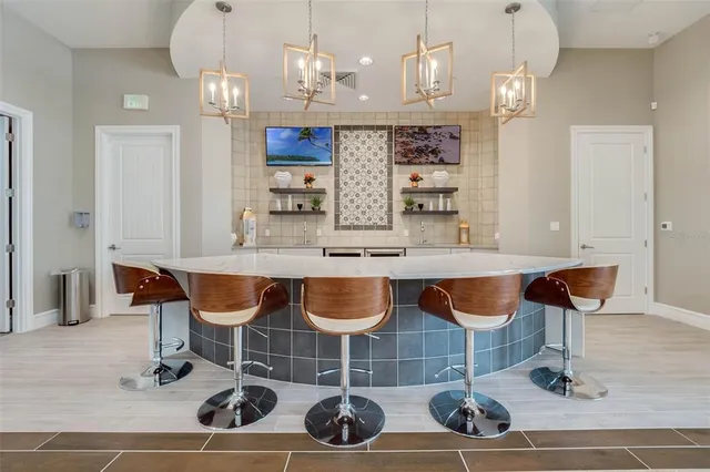 a large kitchen with a table and chairs