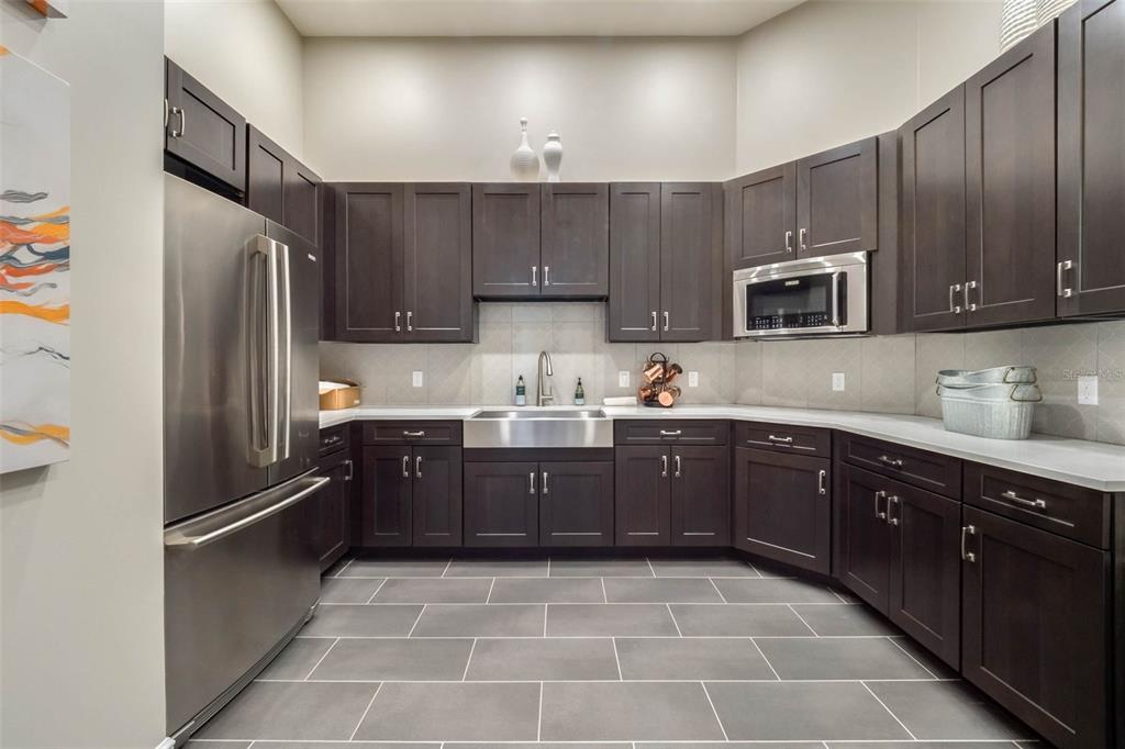 3435 Yellowtop Loop Clermont, FL 34714 - Photo 42 of 42 a kitchen with a refrigerator sink and wooden cabinets