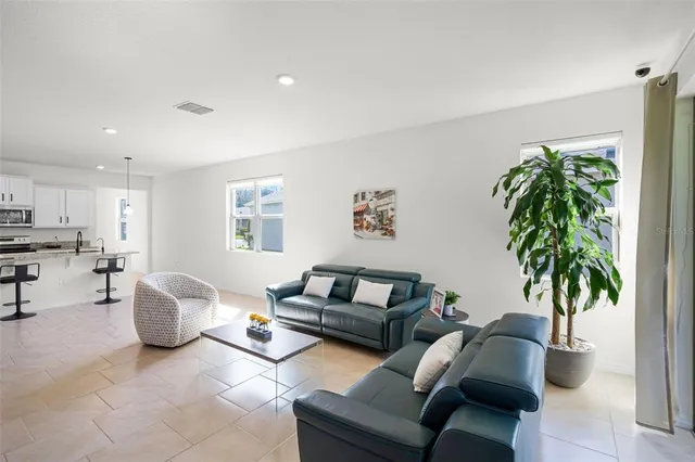a living room with furniture and a potted plant