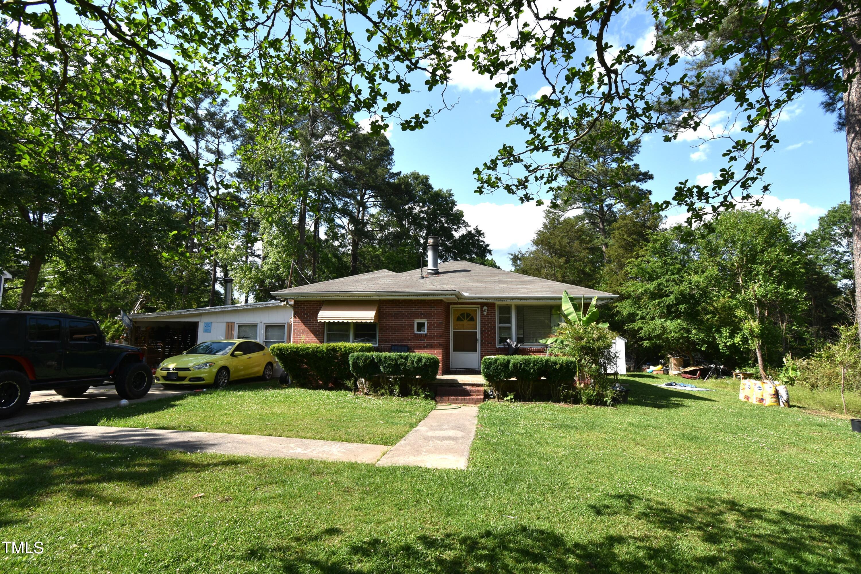 900 Post Avenue Durham, NC 27703 - Photo 2 of 7 a front view of a house with a yard table and chairs