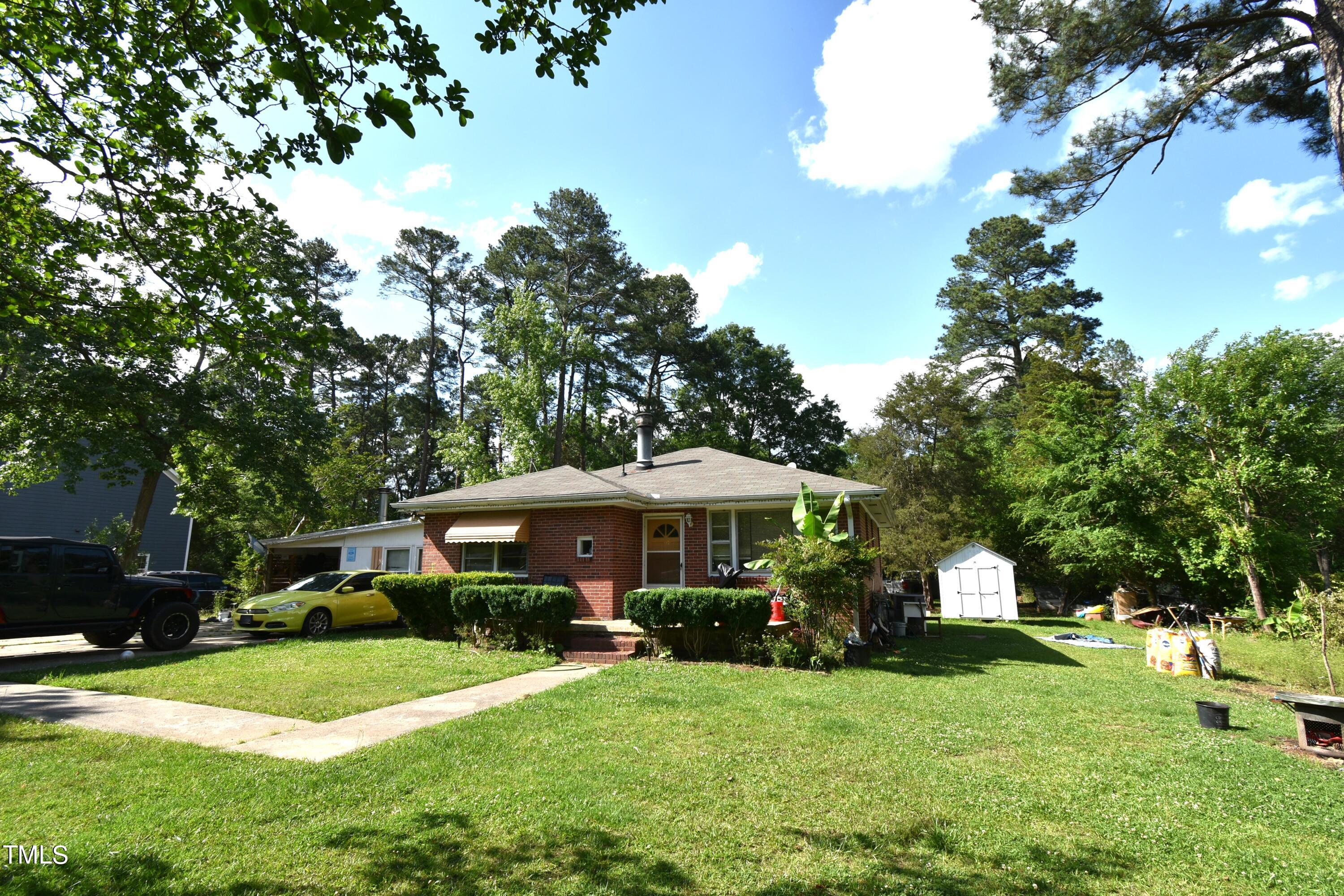 900 Post Avenue Durham, NC 27703 - Photo 3 of 7 a view of a house with a yard and sitting area