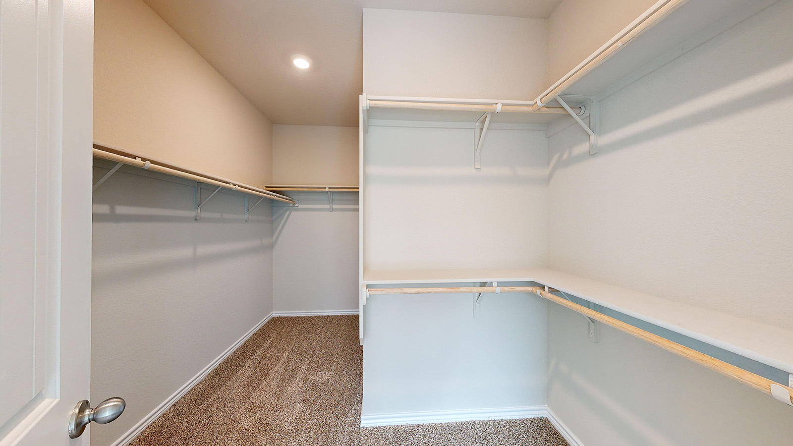 243 Water Wl Road Burnet, TX 78611 - Photo 13 of 23 Spacious walk-in closet featuring multiple shelving units and clothing rods, recessed lighting, and neutral-toned carpeting