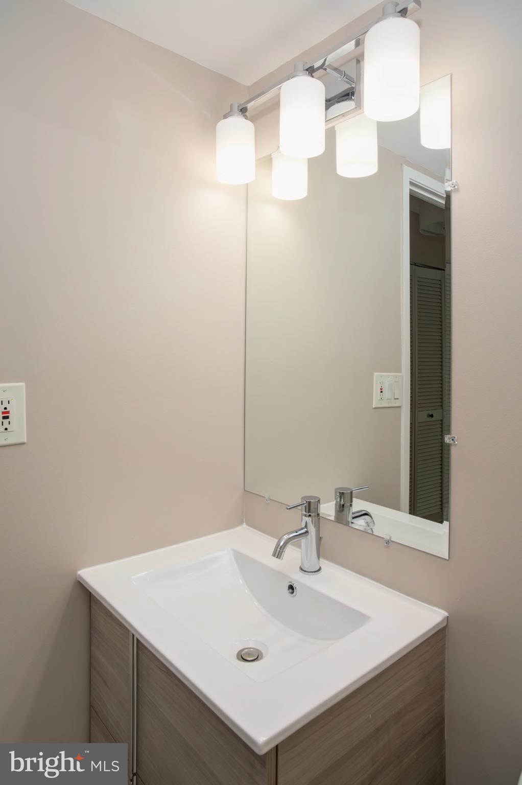 11616 Ivystone Court, Unit 301 Reston, VA 20191 - Photo 25 of 29 a bathroom with a sink vanity and a mirror