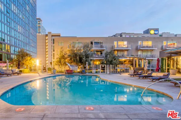 a view of a swimming pool with outdoor seating