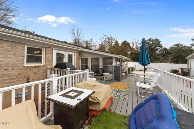 a view of a patio with couches chairs and wooden floor