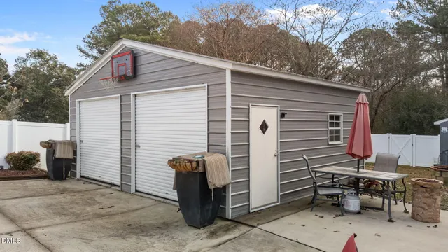 a view of a patio with table and chairs and a barbeque