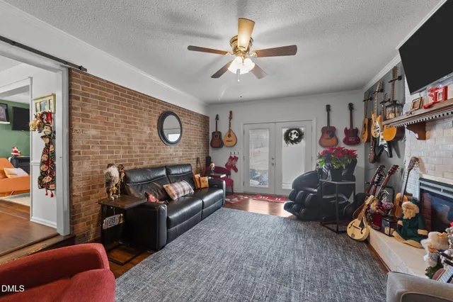 a living room with furniture a window and a flat screen tv