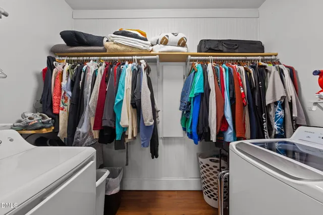 a view of walk in closet with clothes and shoes