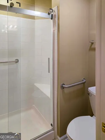 a white toilet sitting next to a bath tub