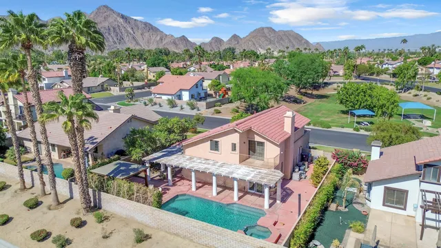 an aerial view of multiple houses with a yard