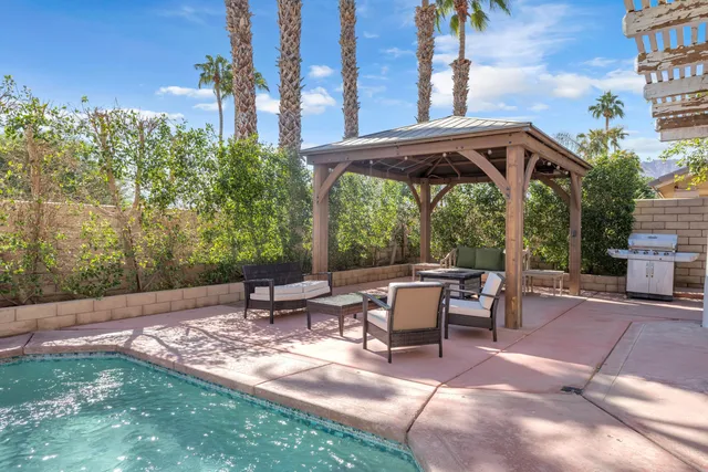 a view of a patio with table and chairs and potted plants