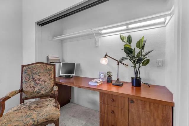 a dining room with furniture and potted plant
