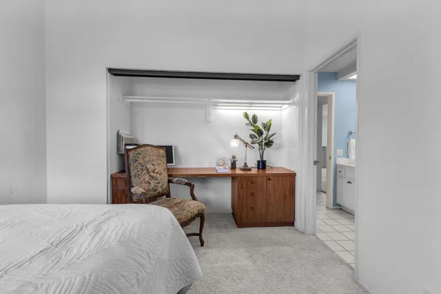 a bed room with a bed and a mirror