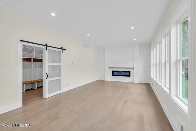 an empty room with a fireplace and window