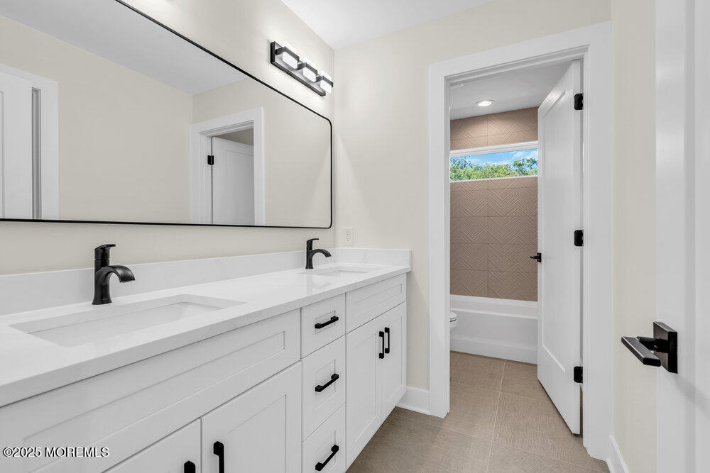 1730 Old Freehold Road Toms River, NJ 08755 - Photo 20 of 31 a bathroom with a double vanity sink and mirror