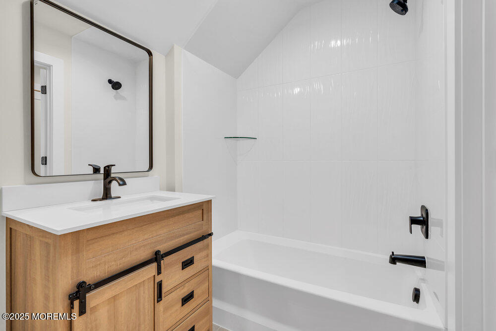 1730 Old Freehold Road Toms River, NJ 08755 - Photo 26 of 31 a bathroom with a sink a bathtub and a mirror