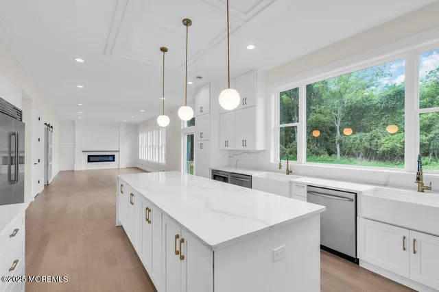 a large white kitchen with a large window