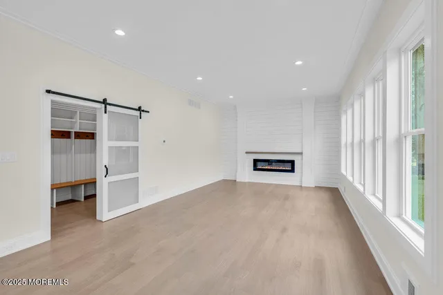 a view of a big room with windows and cabinet