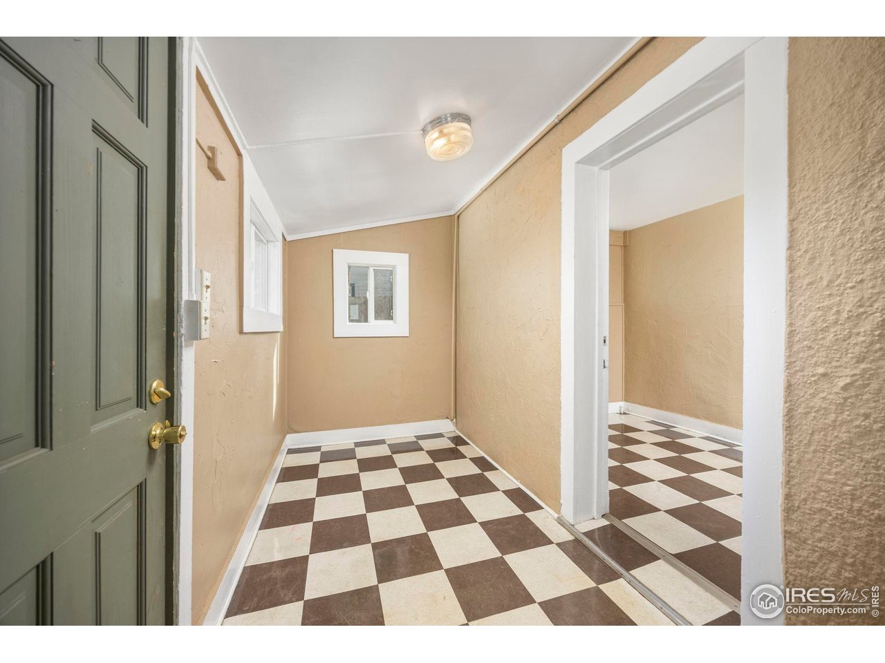 1623 12th Street Greeley, CO 80631 - Photo 24 of 30 a view of a living room with a black white checkered floor
