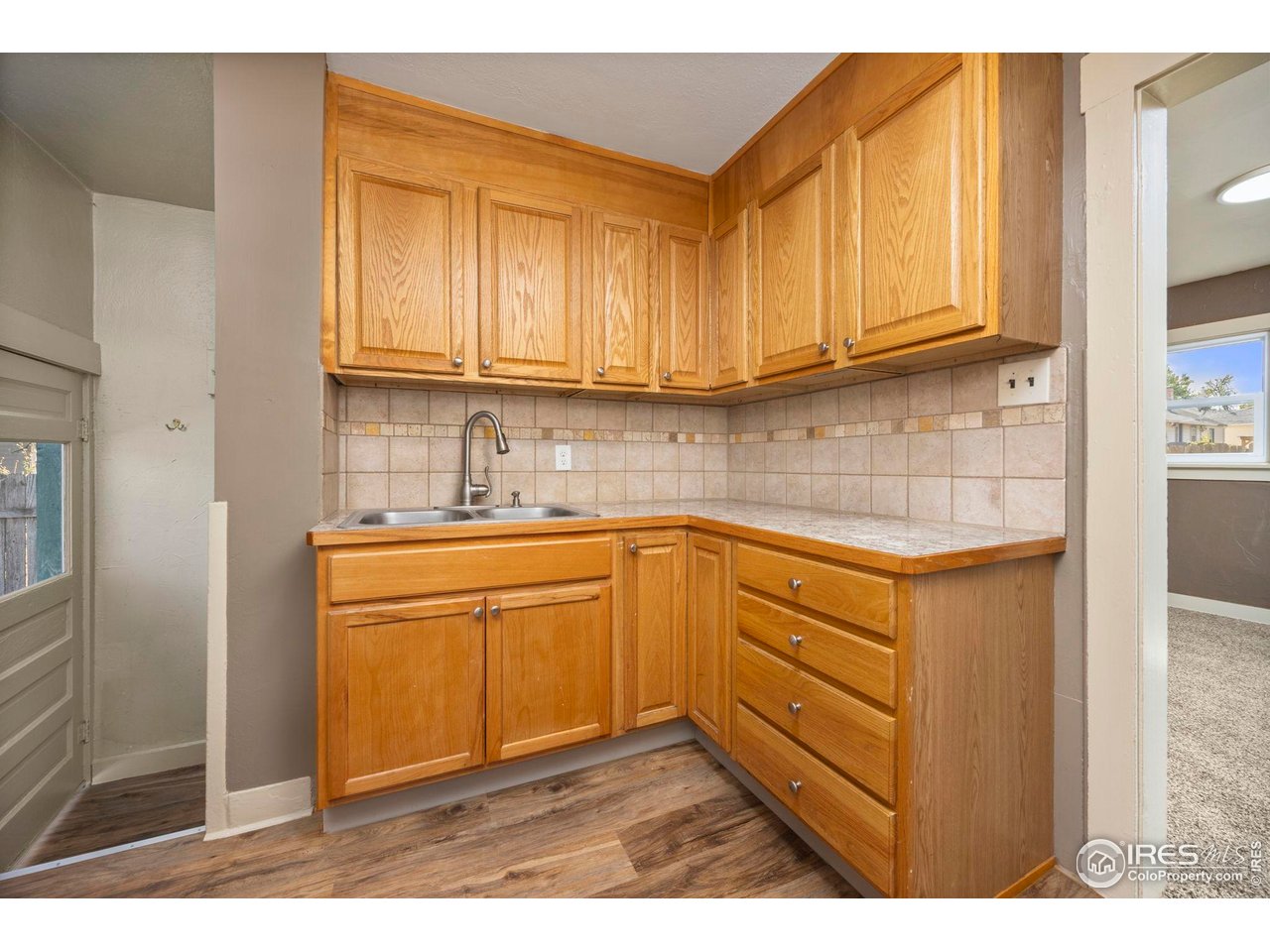 1623 12th Street Greeley, CO 80631 - Photo 10 of 30 a kitchen with stainless steel appliances granite countertop a sink stove and cabinets