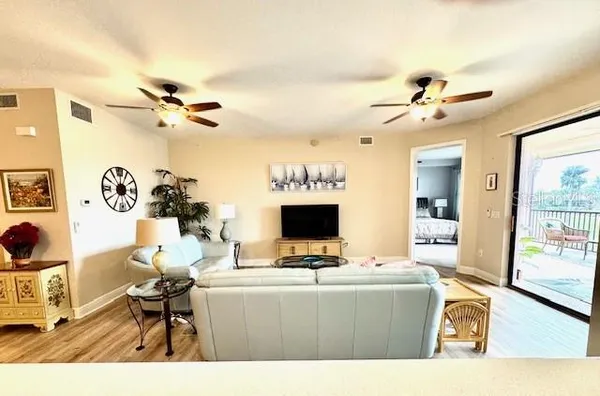a living room with furniture a large window and a fireplace