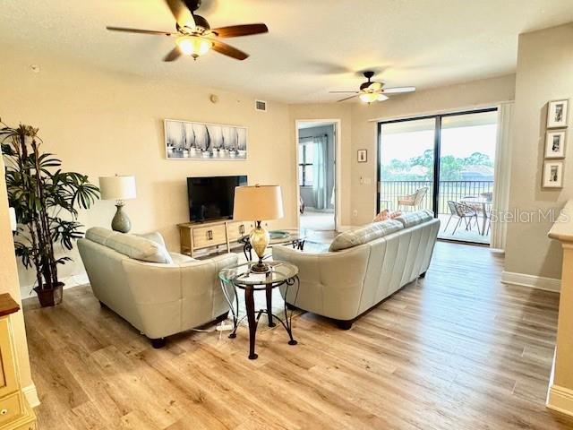 24417 Baltic Avenue, Unit 1102 Punta Gorda, FL 33955 - Photo 12 of 53 a living room with furniture a large window and a fireplace
