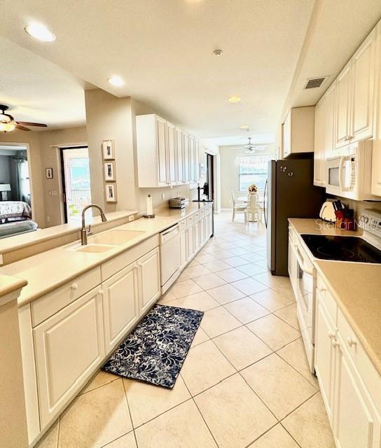 24417 Baltic Avenue, Unit 1102 Punta Gorda, FL 33955 - Photo 15 of 53 a kitchen with stainless steel appliances a refrigerator sink and cabinets